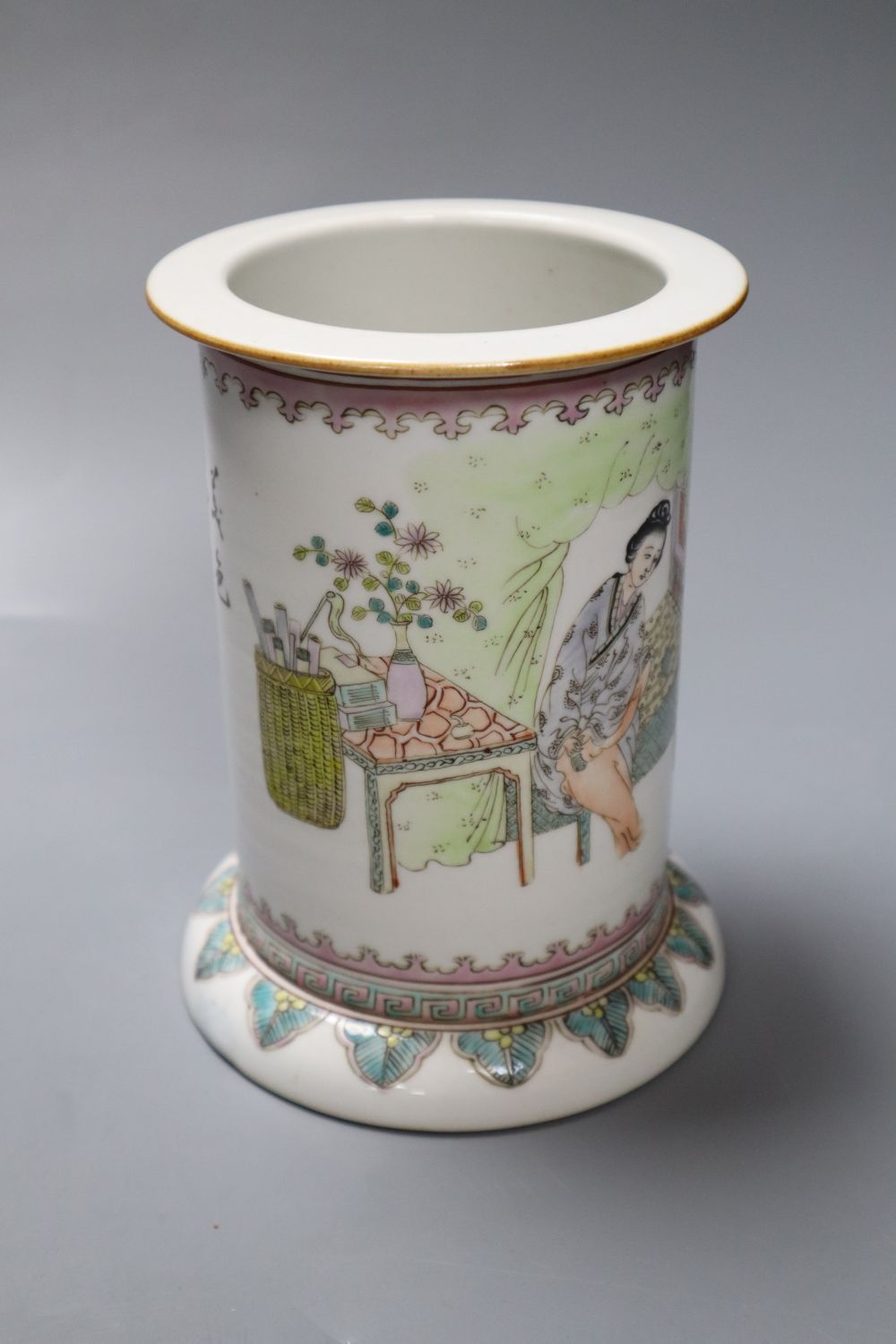 A Chinese cylindrical porcelain brush pot, enamelled with female figures and script, 15cm